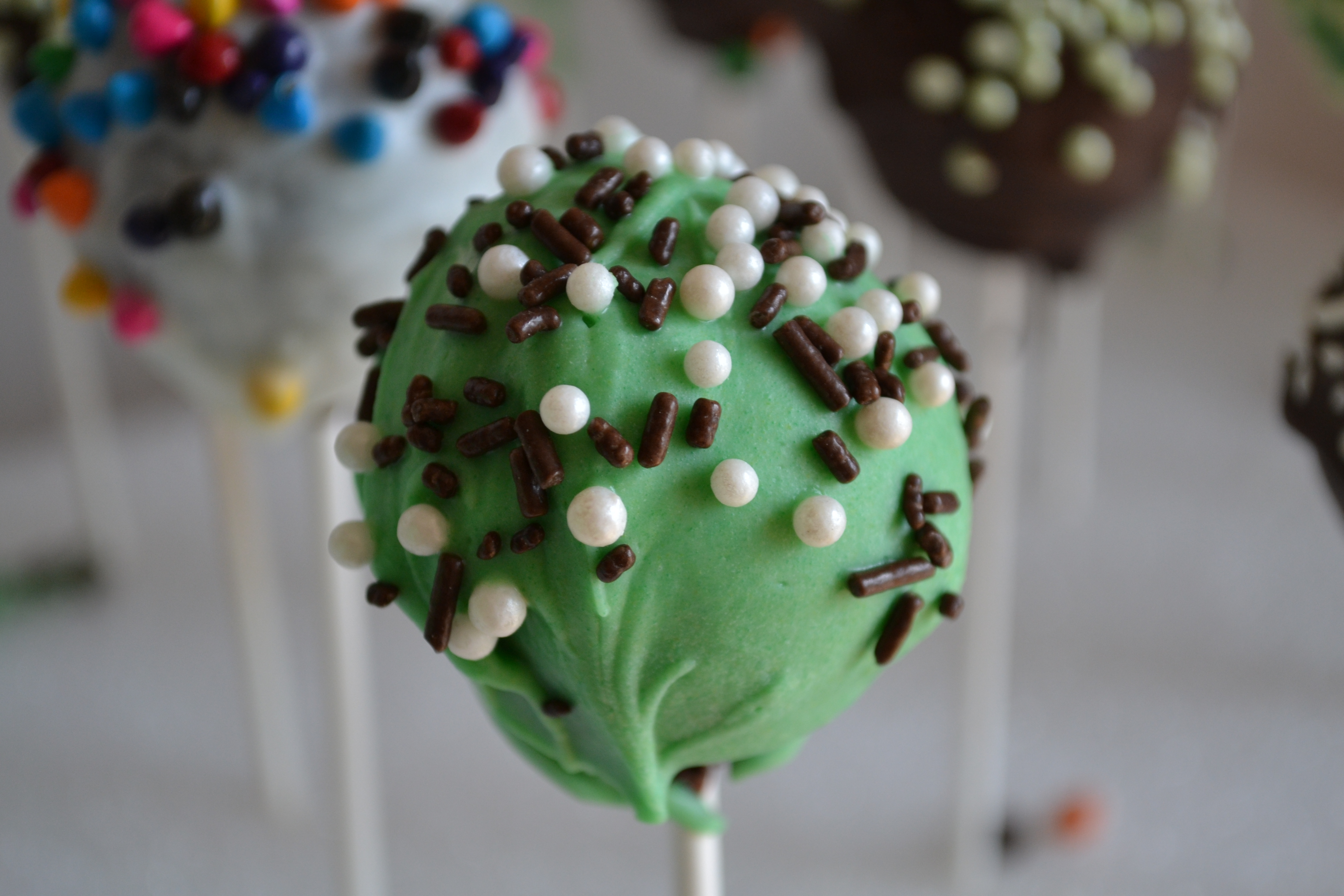 Green, brown, and white cake pops