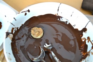 Here is the tough part: use the spoon to dunk the banana slice into the chocolate and then using a combination of the spoon and your fingers, flip it over and make sure the slice is totally covered. Use the spoon to remove it from the chocolate and set it on the wax paper. 